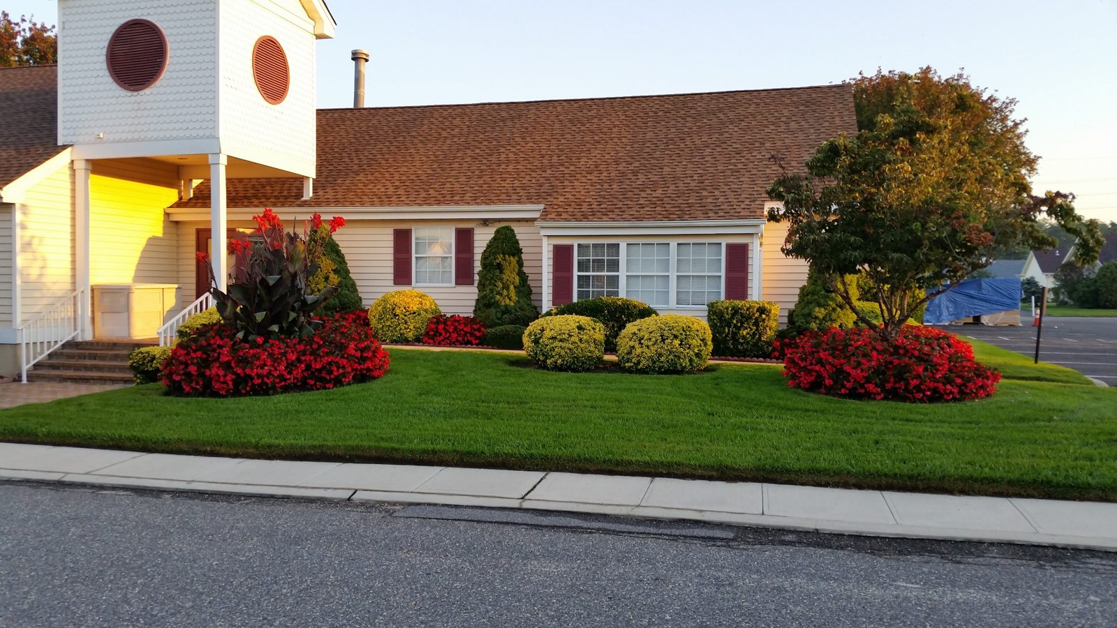 Brown architectural shingle roof on a Long Island property with manicured landscaping